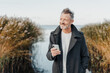 © contrastwerkstatt - Active middle-aged man enjoying a day on a cold beach in early spring