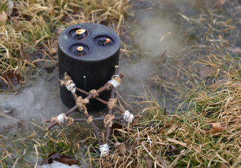 Magic ritual with black candle and pentagram in winter outside.  Esoteric, gothic and occult background, Halloween mystic and wicca concept outdoors.