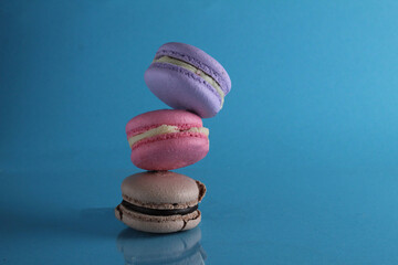 Wall Mural - flying flying levitating food macaroon on a blue background with room for text