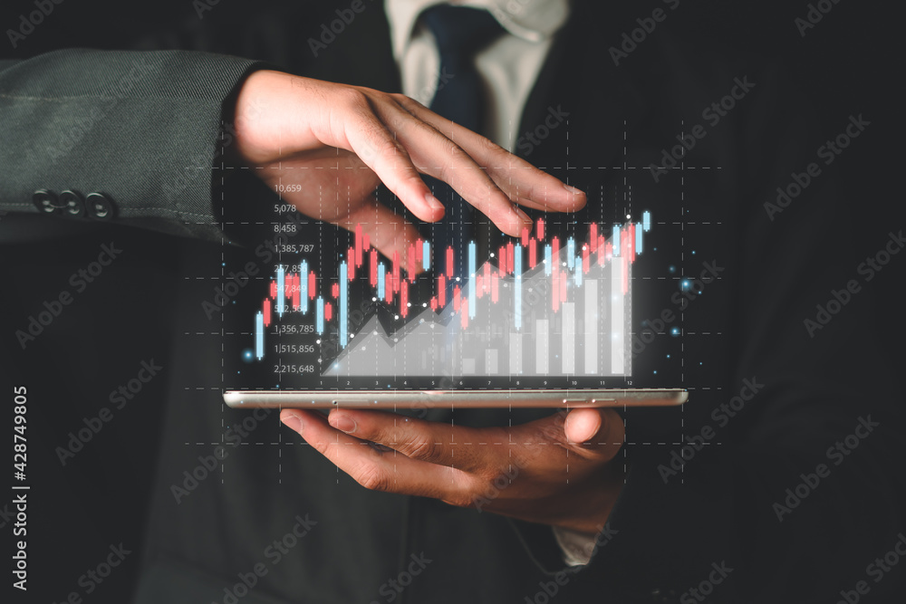 Businessman holding a tablet with virtual screen chart from the digital ...