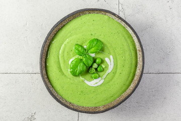 Wall Mural - Summer cream soup with green pea, broccoli and basil. vegetarian food. top view
