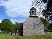An Old Church With A Wooden Tower In The English Countryside