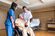 © Thirawatana - Doctor and patient healthcare concept. doctor and nurse, patient using tablet on wheelchair in hospital.
