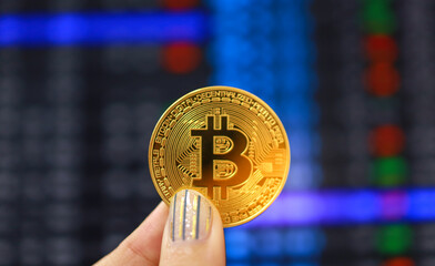 Cryptocurrency symbol bitcoin. Gold Digital Currency Money Investing in virtual assets. Hand hold Golden bitcoin Investment market trend financial world cryptocurrency and technology