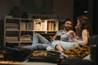 © cherryandbees - couple relaxing on weekend together at home listening to a music on record player