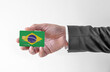 © bennian_1 - Bank credit plastic card with flag of Brasil holding man in elegant suit