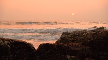 Wall Mural - Beautiful view sunset over the sea, ocean waves crashing on the beach shore