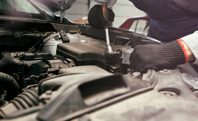 Wall Mural - The mechanic fixing the car in the garage