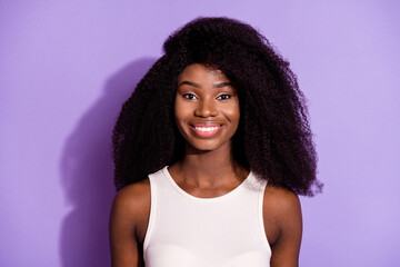 Wall Mural - Portrait of attractive cheerful wavy-haired girl wearing white singlet isolated over bright violet purple color background