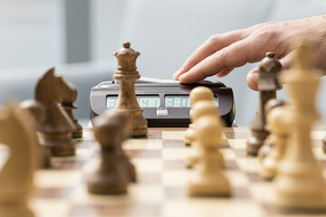 Chess player hitting the chess clock