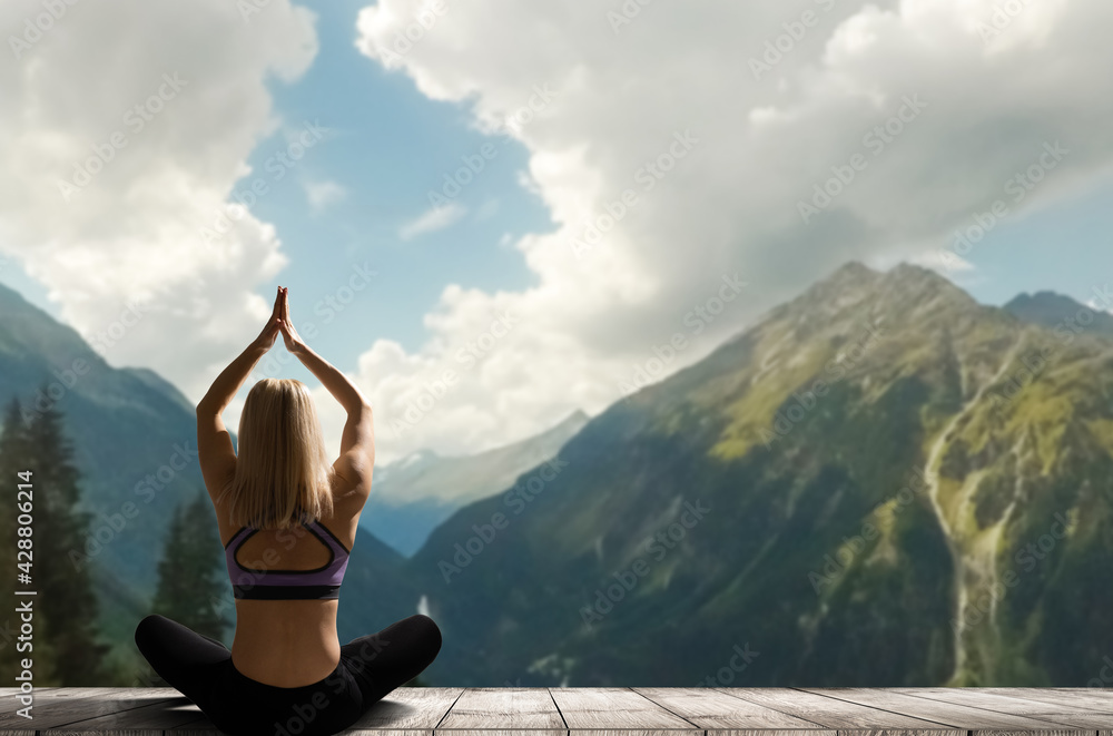 Young woman practicing yoga in the nature. female happiness. Landscape background - obrazy, fototapety, plakaty 