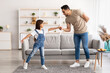 © Prostock-studio - Dad and daughter dancing in living room together
