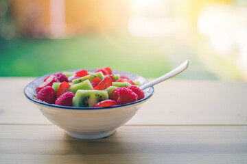 Breakfast fruit bowl with strawberries and kiwis, close up. Healthy lifestyle for vegetarians.