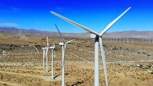 Windmills, Wind Turbines Aerial 4k Drone Sweep L To R, Energy, Green, Renewable, Huge Power Generating Farm On Desert Hills, With Mt San Gorgonio In BG In Palm Springs, Coachella, Cabazon, California