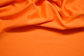 Orange textile pattern as a background. Orange material texture on fabric