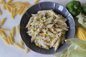 Wall Mural - White sauce penne pasta with capsicum and sweet corn