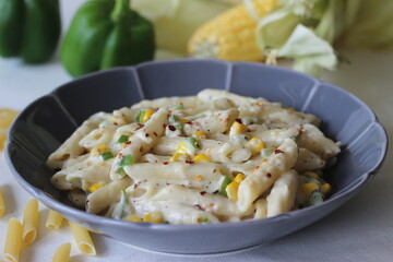 Wall Mural - White sauce penne pasta with capsicum and sweet corn