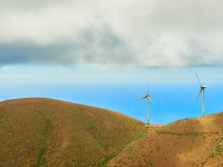 Renewable energy wind power plant with windmills on a mountain in the middle of nature