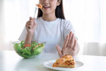 Wall Mural - Young Asian woman choose to eat green salad for good health.