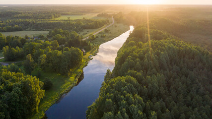 aerial view along natural river toward sunny morning horizon and wilderness of the national park on 