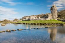 Ogmore Castle, A Ruined Norman Castle Near Bridgend, South Wales.  The Castle Is Reflected On The Smooth Water Of The River Ogmore.