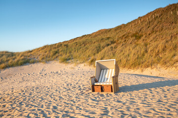 Wall Mural - empty roofed wicker beach chair, north sea coast, germany