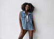 Lifestyle photo of black woman in denim clothes with afro hairstyle isolated on white background