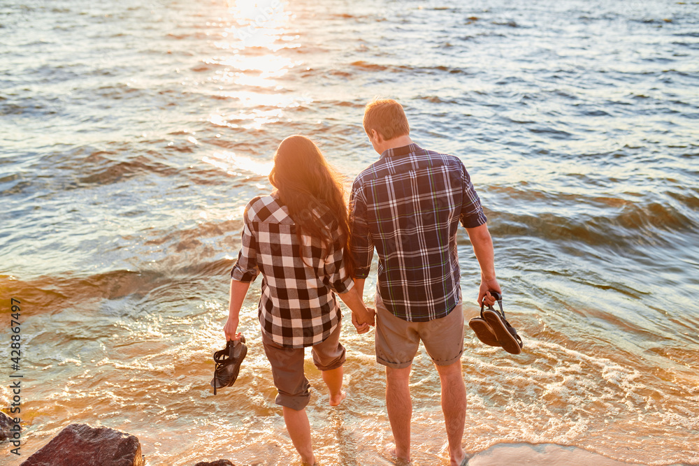 Couple walking on the beach Stock Photo | Adobe Stock