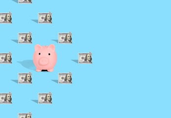 . Pattern of American dollar banknotes and pink piggy bank on bright blue background. The concept of financial savings and miscellaneous transactions.