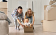 © insta_photos - Overjoyed excited happy householders renters tenants parents pushing carton box with kid riding in new apartment, having fun in their first moving day to real estate property. New home concept.