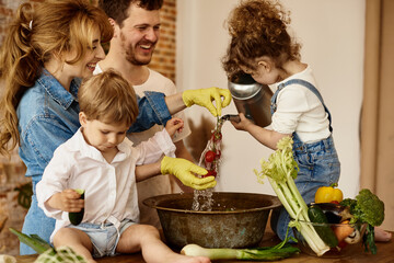 Wall Mural - happy family with their children cooking in the kitchen