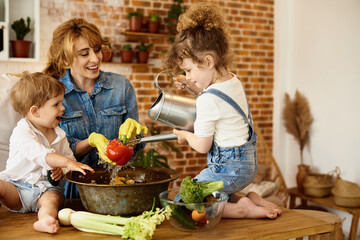 Wall Mural - happy family with their children cooking in the kitchen