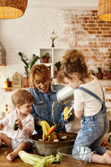 Wall Mural - happy family with their children cooking in the kitchen