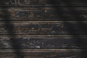 Old, burnt wooden wall. Dark background