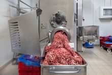 The Meat In The Grinder. The Meat Industry. Minced Meat Being Extruded From An Industrial Mincing Machine.