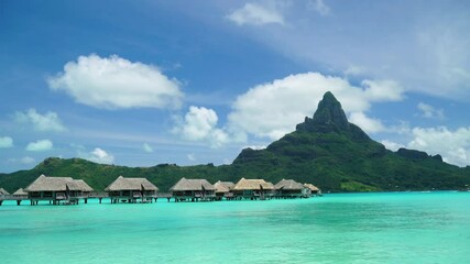 Wall Mural - Bora Bora vacation paradise island with overwater bungalows resort hotel in coral reef lagoon ocean and beach. Mount Otemanu in background, Bora Bora, French Polynesia, Tahiti, South Pacific Ocean