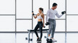© Mongkolchon - athletic couple workout with dumbbell weight lifting in gym and fitness