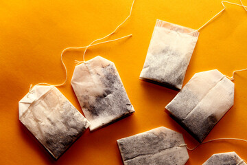 Wall Mural - Close up of tea bag in yellow background