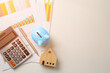 © Kt Stock - Piggy bank and model house, investment graph, calculator, pen, House mortgage financial and Property investment concept.