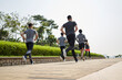 © imtmphoto - group of asian young adults running outdoors in park