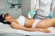 Hair removal on female body, laser epilation at cosmetology salon. Hispanic woman during body hair removal with medical laser