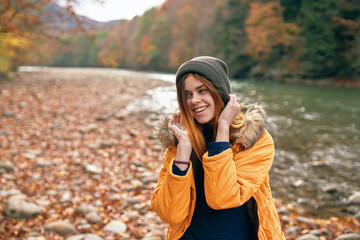 cheerful woman in autumn forest river fresh air