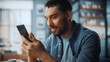© Gorodenkoff - Handsome Caucasian Man Using Smartphone in Cozy Living Room at Home. Freelancer Working From Home. He's Browsing the Internet and Checking Videos on Social Networks and Having Fun.