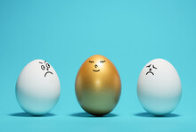 Golden Egg With A Funny Smiling Face Among The White Eggs. Concept Of Exclusivity, Best Choice, Hiring.