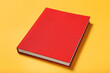 © New Africa - Book with red cover on yellow background