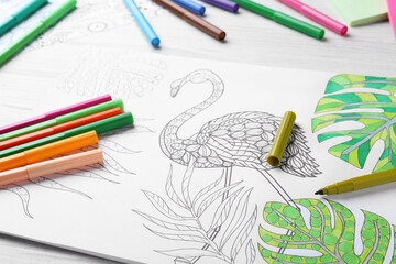 Poster - Antistress coloring page and felt tip pens on white wooden table, closeup