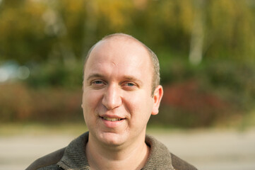 Natural looking guy with blue eyes smiling, portrait 