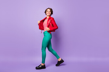 Full body profile side photo of young cheerful girl happy positive smile go walk look empty space isolated over violet color background