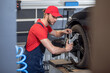 © zinkevych - Man working near wheel in car service
