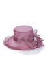 Subject shot of ash-pink organza hat decorated with large tissue flower and pearl bead. Stylish hat for evening party is isolated on the white backdrop.